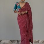 Fuchsia colored saree with blue velvet blouse